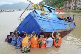 Военные полицейские помогают рыбакам после тайфуна Трами в Ниндэ, провинция Фуцзянь.