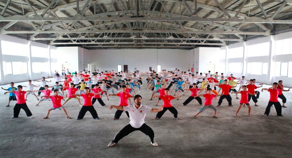 Школьники занимаются гимнастикой   Тайцзицюань в городе Цзяоцзо провинции Хэнань. Во время летних каникул многие школьники записываются на курсы обучения Тайцзицюань.