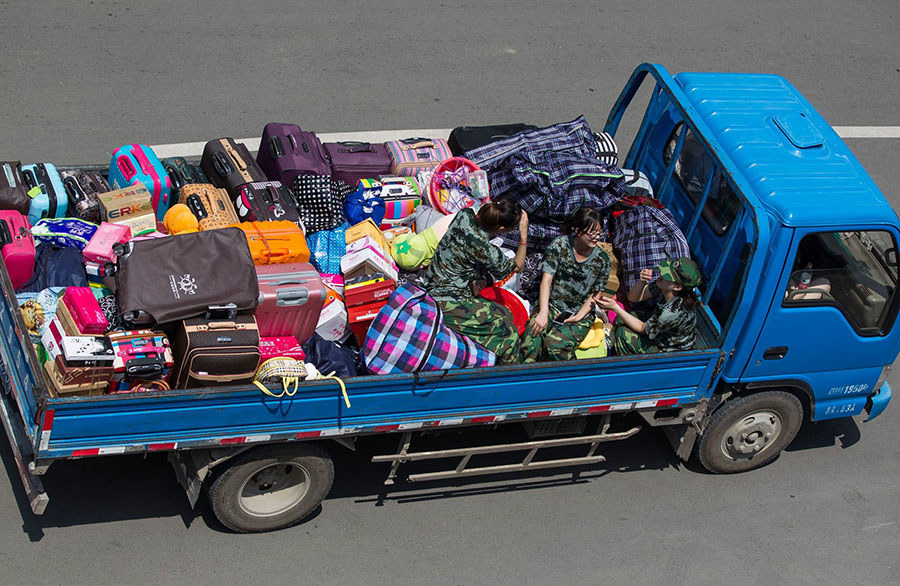 Студентки колледжа наняли грузовик, чтобы перевезти вещи в новое общежитие в Чанчуне, провинция Цзилинь. 