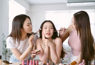638822928026367935Two_girls_doing_the_makeup_of_a_girl_in_the_middle_of_them._.jpg