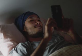 asian-man-using-a-mobile-phone-while-lying-in-bed-at-home-late-at-night-free-video-1.jpg