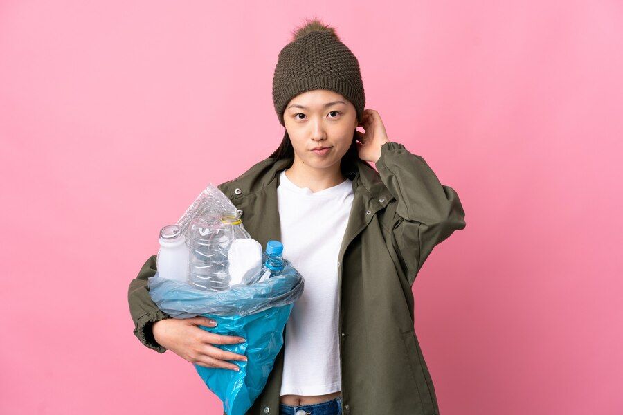 chinese-girl-holding-bag-full-plastic-bottles-recycle-isolated_1368-173916.jpg